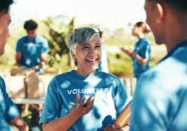 Volunteers chat on a sunny day