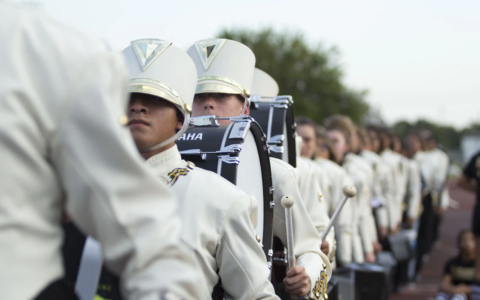 marching band in white uniforms