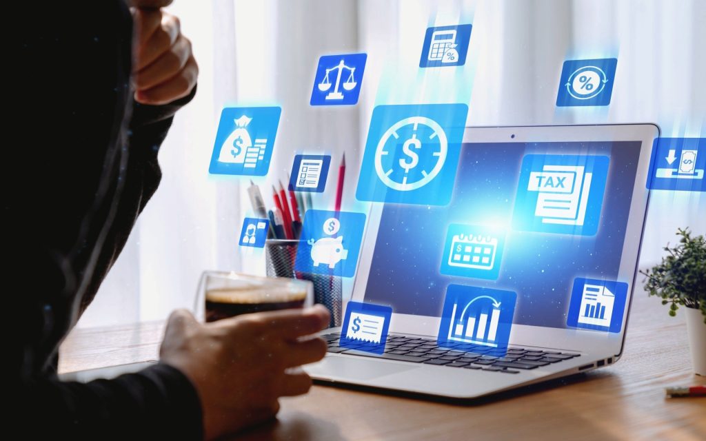 Convince Your Nonprofit Board That Financial Management Software Isn’t Optional A computer with floating financial symbols