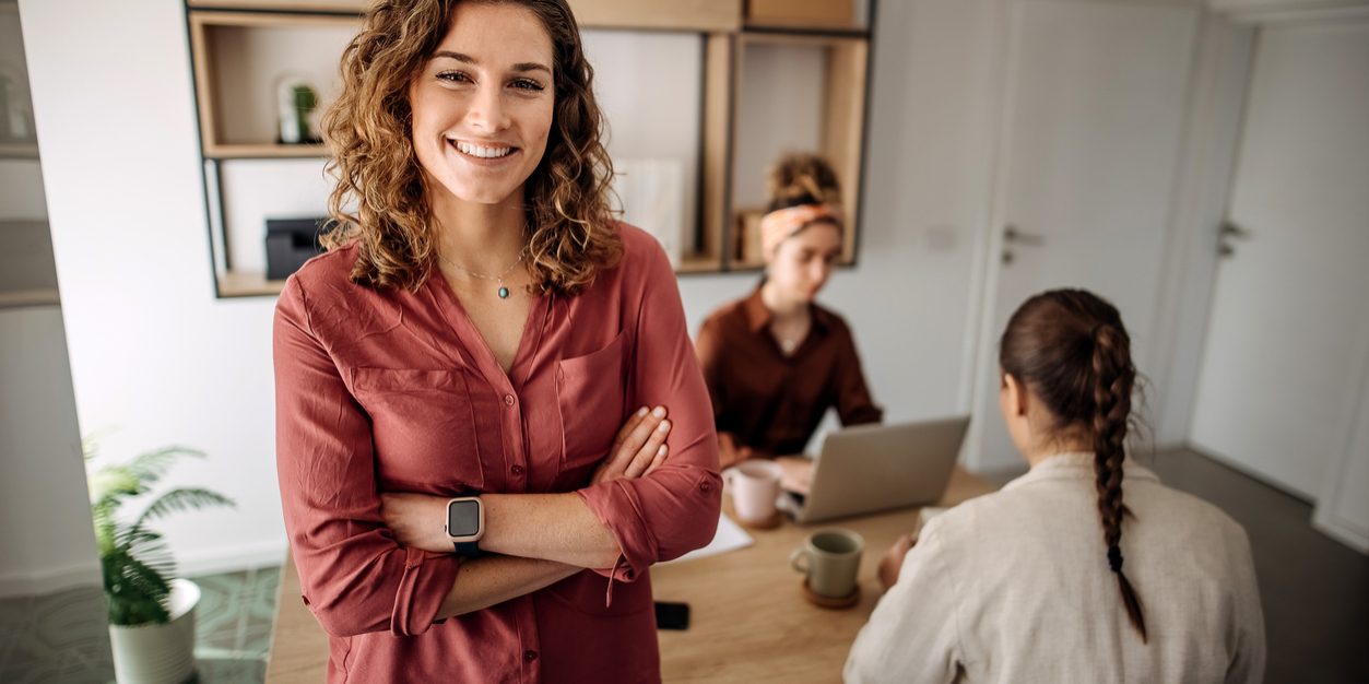 Portrait of an attractive young businesswoman standing  in her office with her arms folded during the day